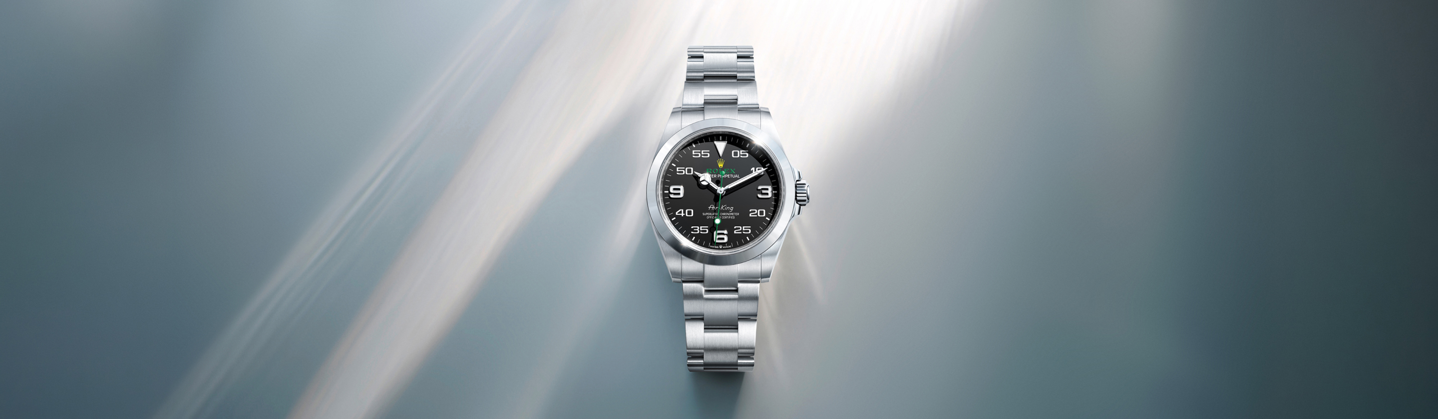 Rolex Air-King in Oystersteel with black dial on silver metallic light-streak background