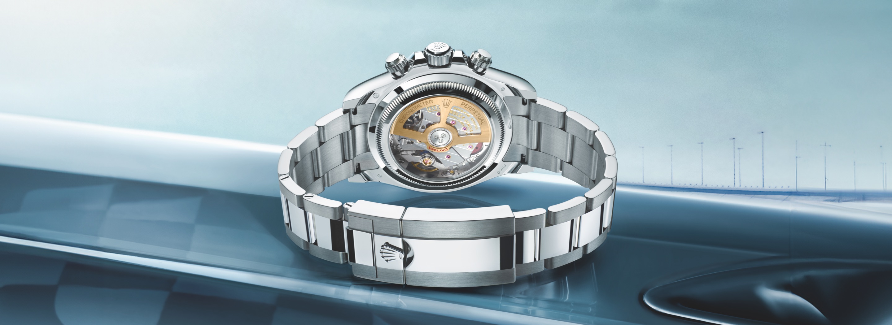 Rear view of the Rolex Cosmograph Daytona in 950 platinum on an Oyster bracelet, showing the transparent sapphire caseback revealing the yellow gold cut-out oscillating weight of caliber 4131