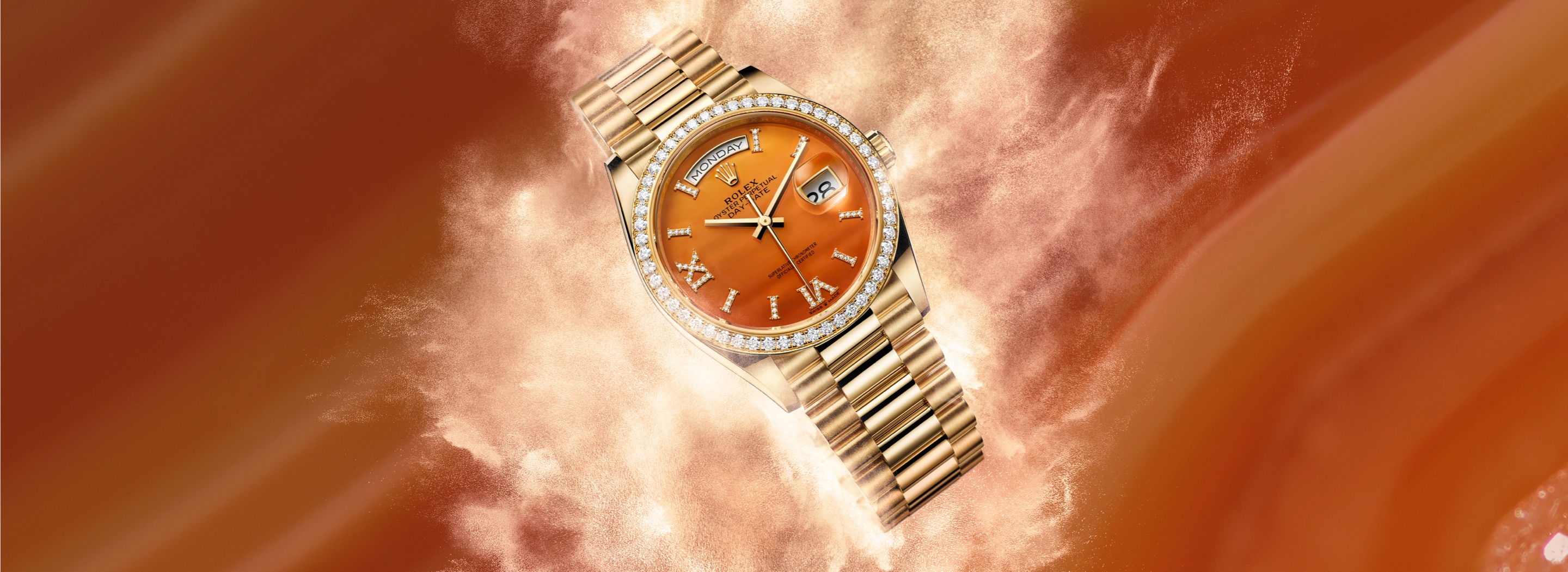 Rolex Day-Date 40 in yellow gold with orange carnelian dial, diamond Roman numerals and diamond-set bezel on a President bracelet
