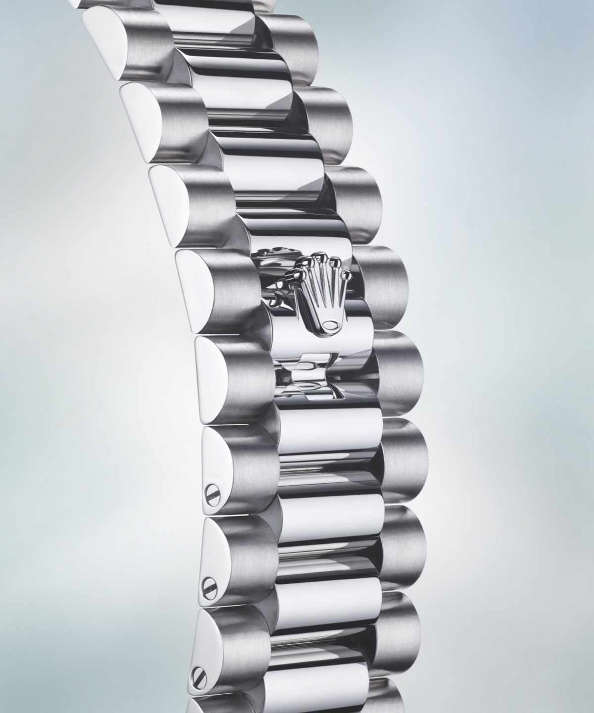 Close-up of the Rolex Day-Date three-piece link President bracelet in 950 platinum showing the crown clasp detail