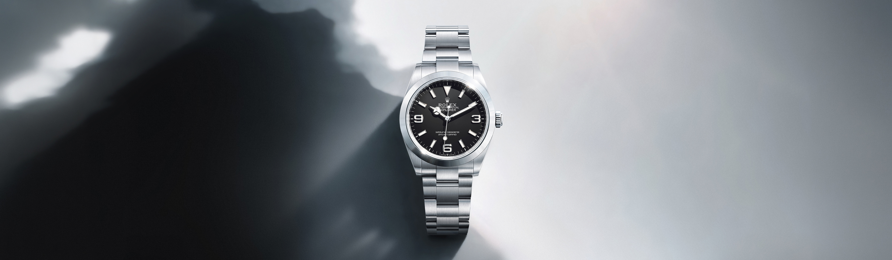 Rolex Explorer 36 in Oystersteel with black dial against stormy mountain backdrop