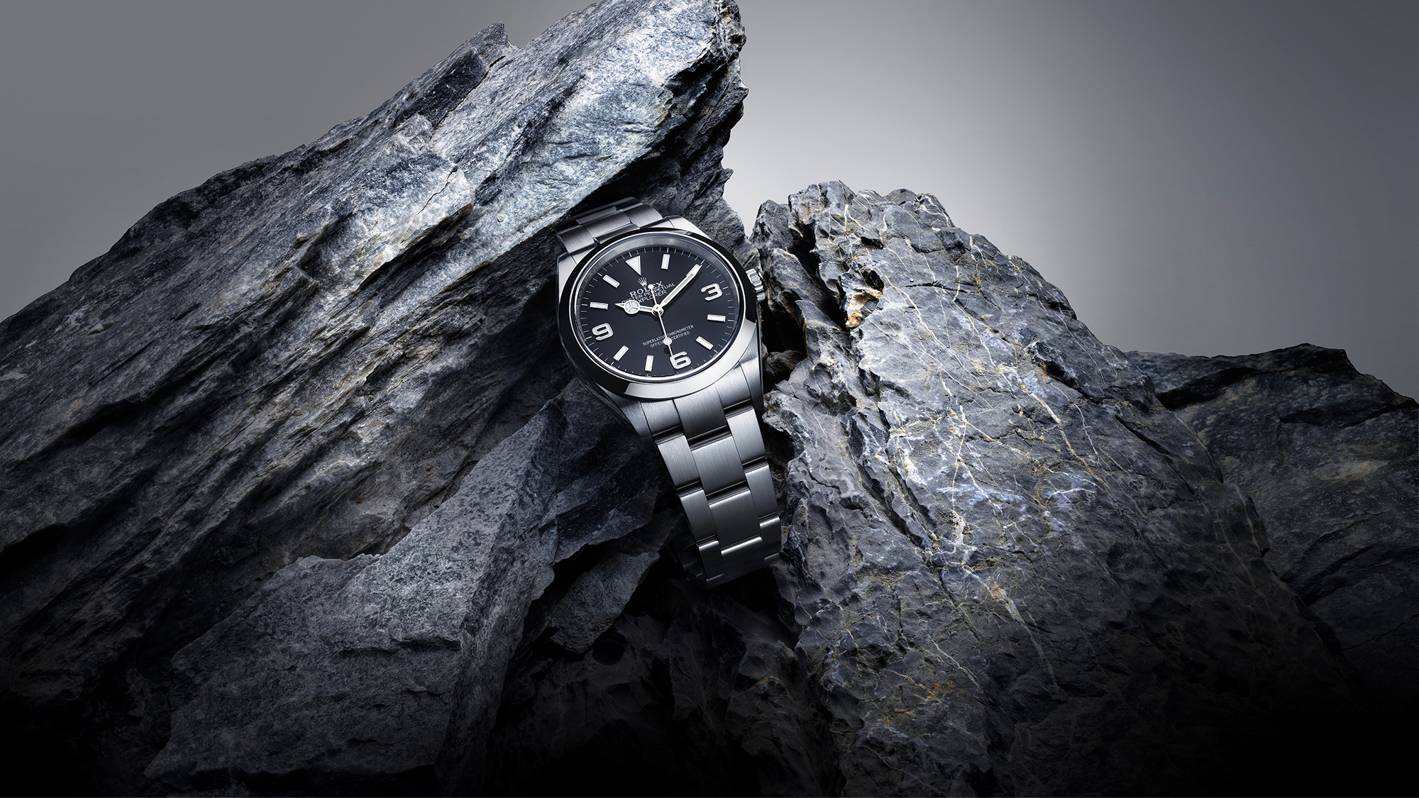 Rolex Explorer 36 in Oystersteel wedged between two jagged dark rock faces