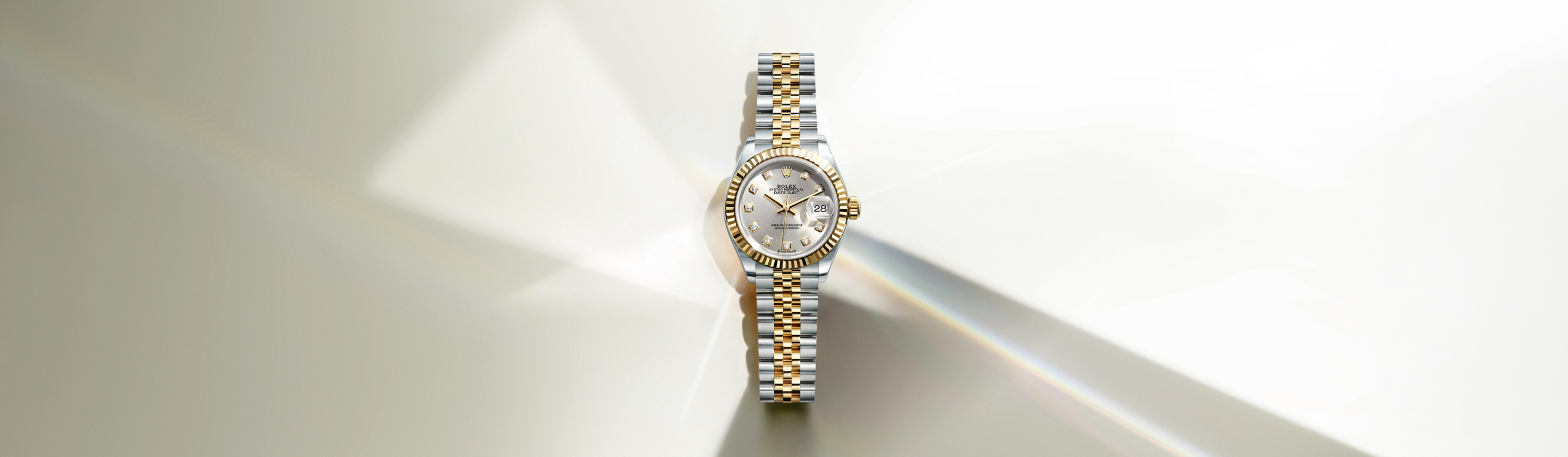 Close-up of the Rolex Lady-Datejust dial set with diamonds on an Oystersteel and yellow gold Rolesor case