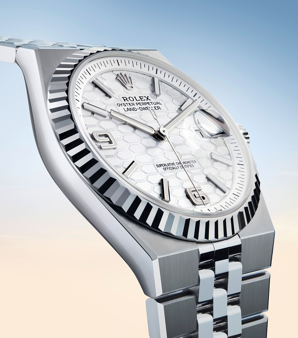 Close-up of the Rolex Land-Dweller white dial featuring the laser-engraved honeycomb motif and Chromalight hour markers