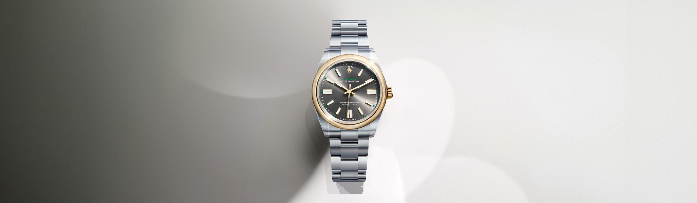 Close-up of the Rolex Oyster Perpetual dial showing the Rolex crown logo and baton hour markers