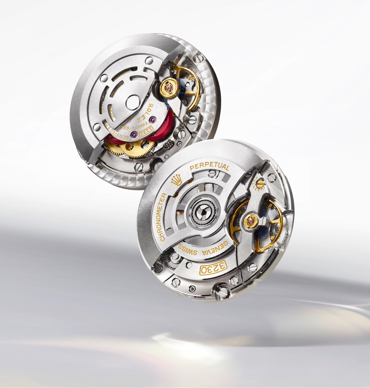 Rolex Oyster Perpetual caliber 2232 and caliber 3230 self-winding movements side by side, showing the Perpetual rotor and movement architecture