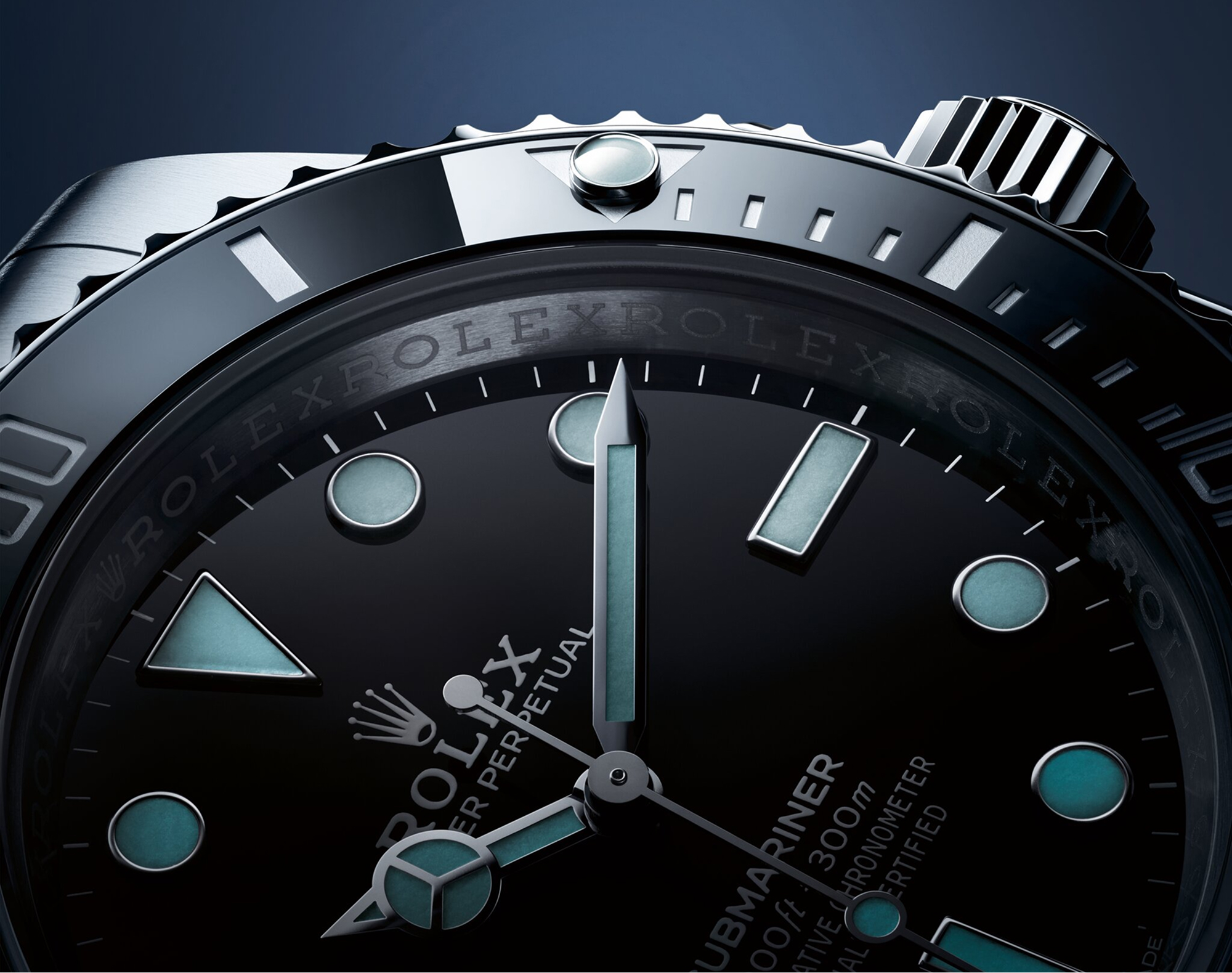 Close-up of the Rolex Submariner black dial and black Cerachrom bezel, highlighting the Chromalight luminescent hour markers, Mercedes hands and the Submariner 300m inscription
