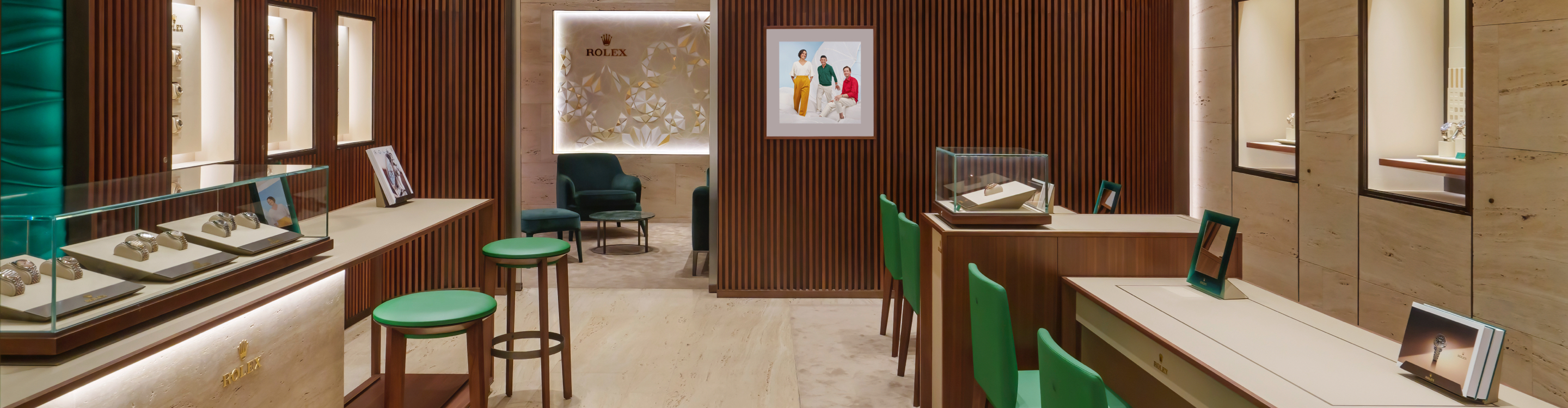 Rolex showroom interior with watch display cases, green seating, and wood-paneled walls